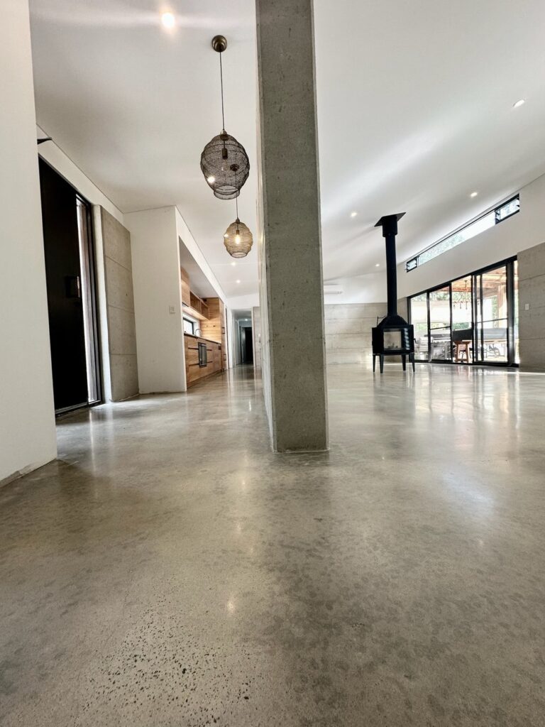 Modern interior with polished concrete floors and pendant lights.