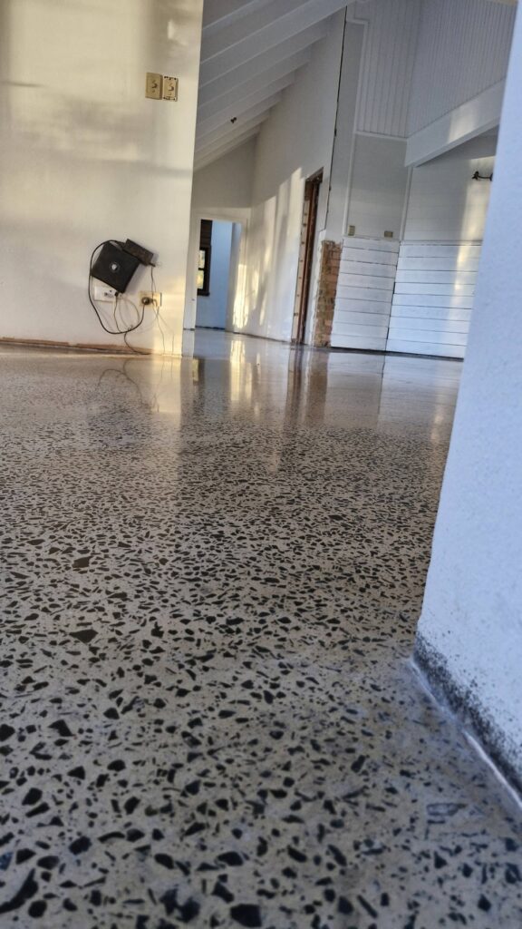 Highly polished terrazzo concrete floor in a modern home interior.